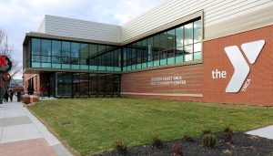 Exterior of the Atchison Family YMCA Cray Community Center with the YMCA logo on a brick facade