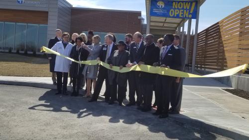 Leaders from University Health/Truman Medical and the YMCA of Greater Kansas City gather outside new medical center for a ribbon cutting.