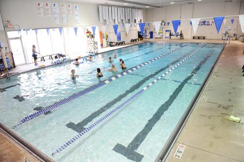 Angled view of an indoor pool with swimming lanes.