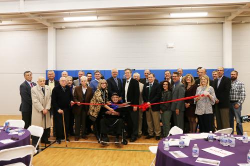 A group of donors and Y leaders pose before the ribbon cutting inside the new community center.