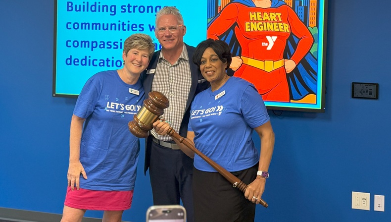 Photo of outgoing Chief Volunteer Officer Dr. Michelle Robin, President and CEO Mark Hulet, and Incoming Chief Volunteer Officer Dr. Andrea Hendricks. Hendricks is holding a large gavel signifying the change in Board of Directors leadership.