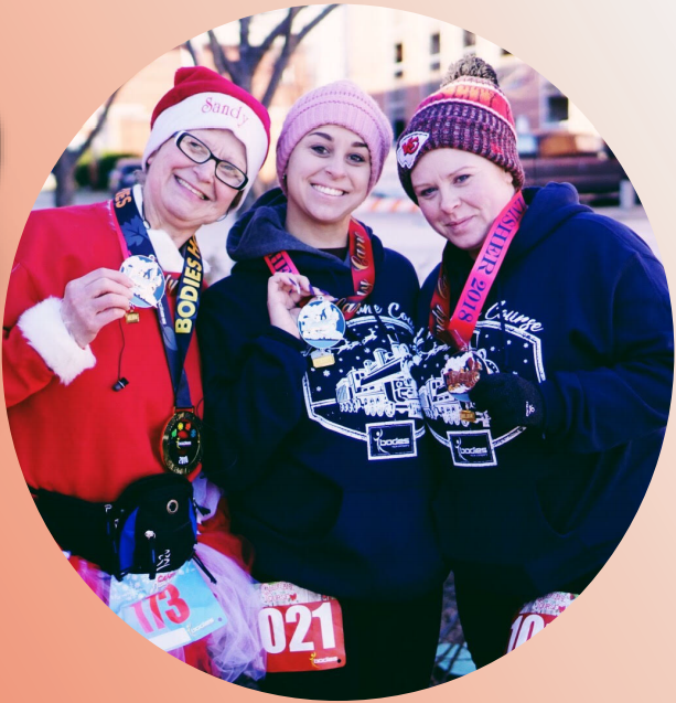 3 competitors hold their medals up after the Candy Cane Course.