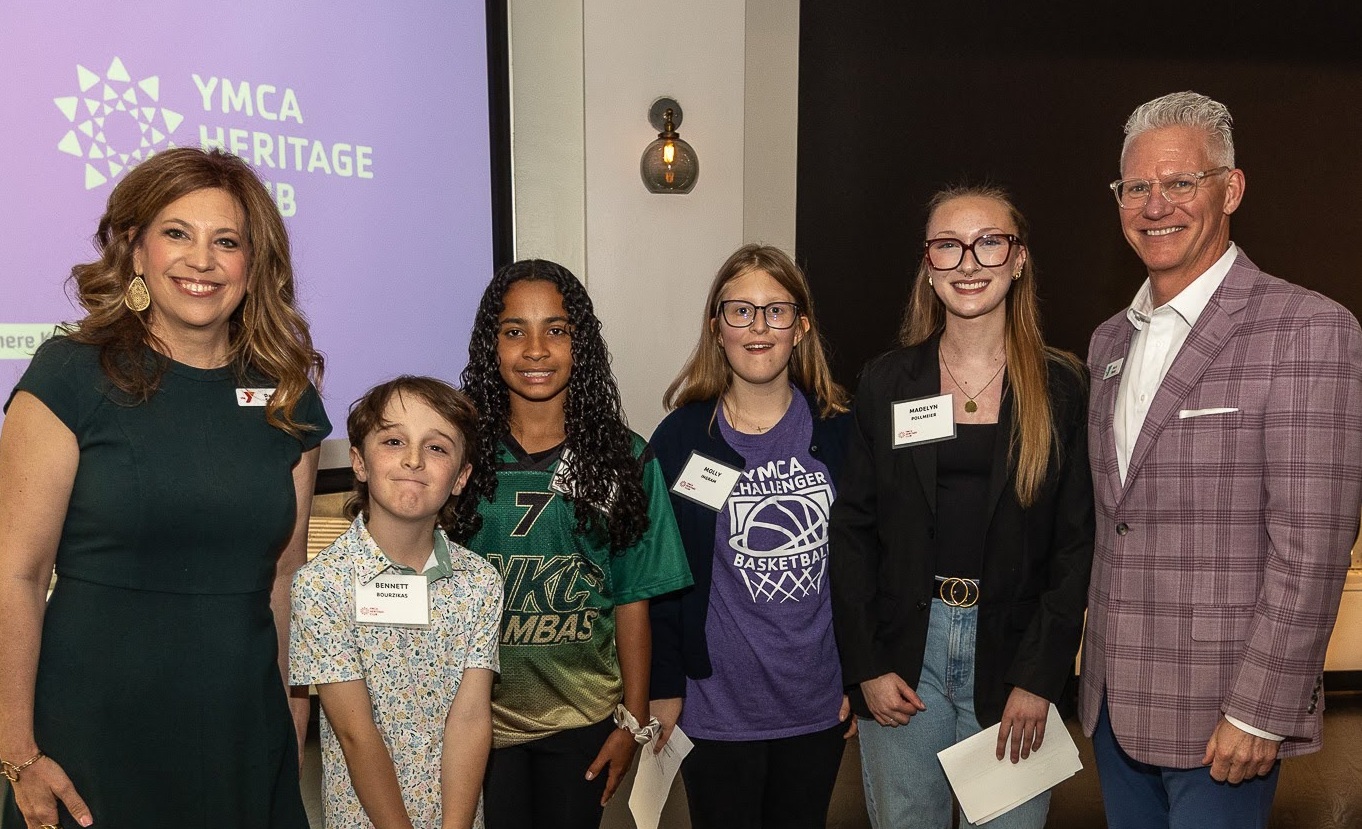 Photo of SVP of Youth Development Darcy Swan, youth program participants, and CEO Mark Hulet