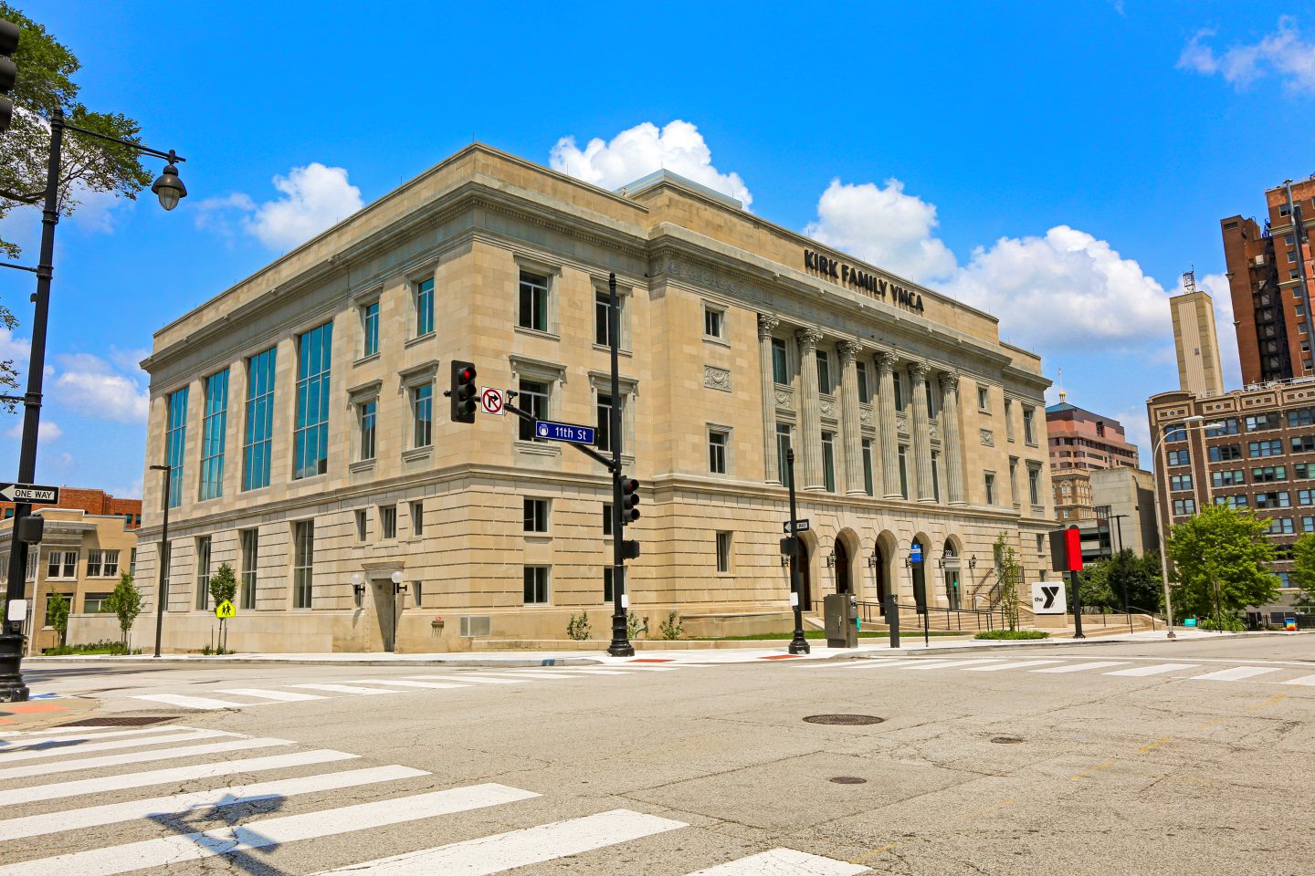 Photograph of the Kirk Family YMCA building from across the street, with kiosk visible from the east entrance of the building.