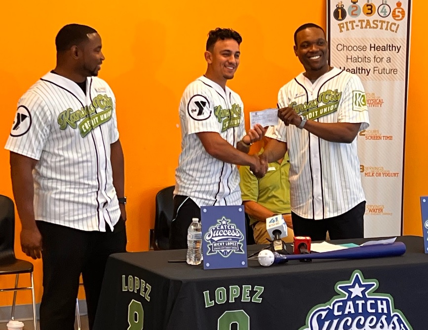 Nicky Lopez presents a check to Andre Sigler, Associate Executive Director of the Linwood YMCA, to fund financial literacy programs.