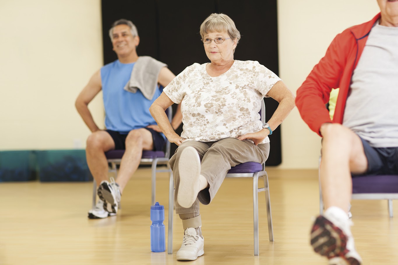 Active Older Adults performing active fall prevention exercises in Kansas City YMCA group class.