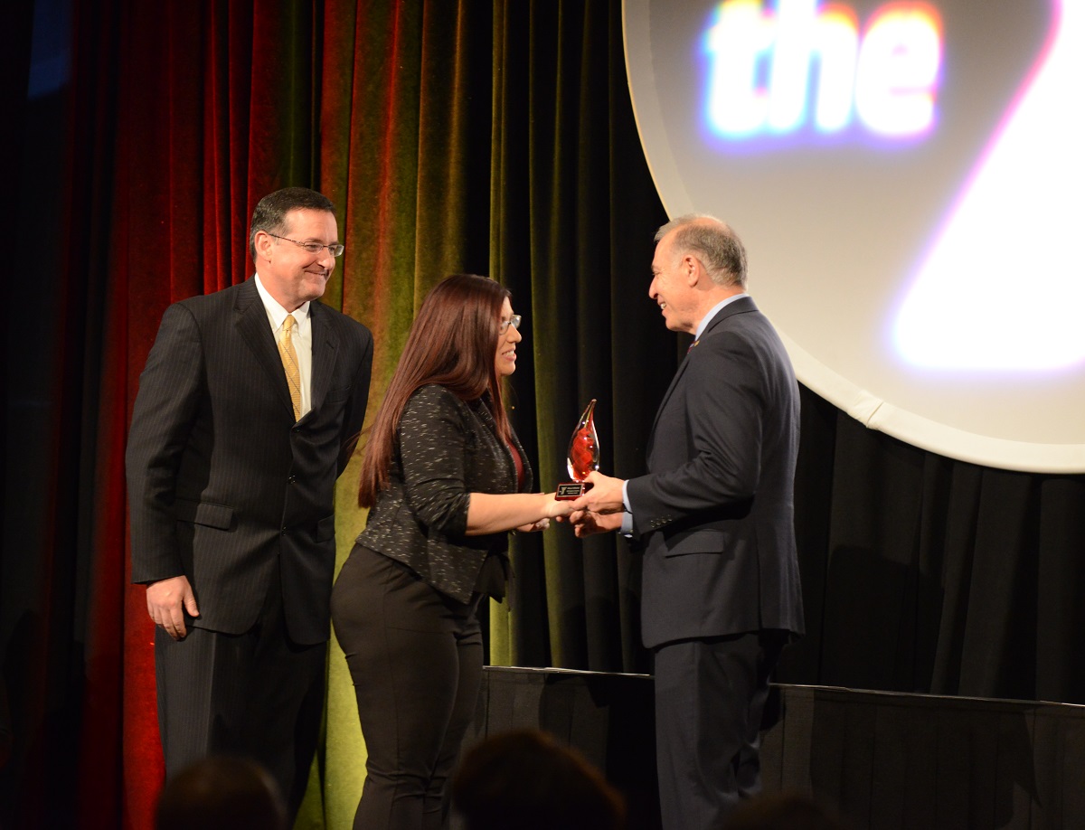 John Passanisi, Chief Volunteer Officer, and John Mikos, Greater Kansas City YMCA President and CEO, handing awards to volunteer award recipient.