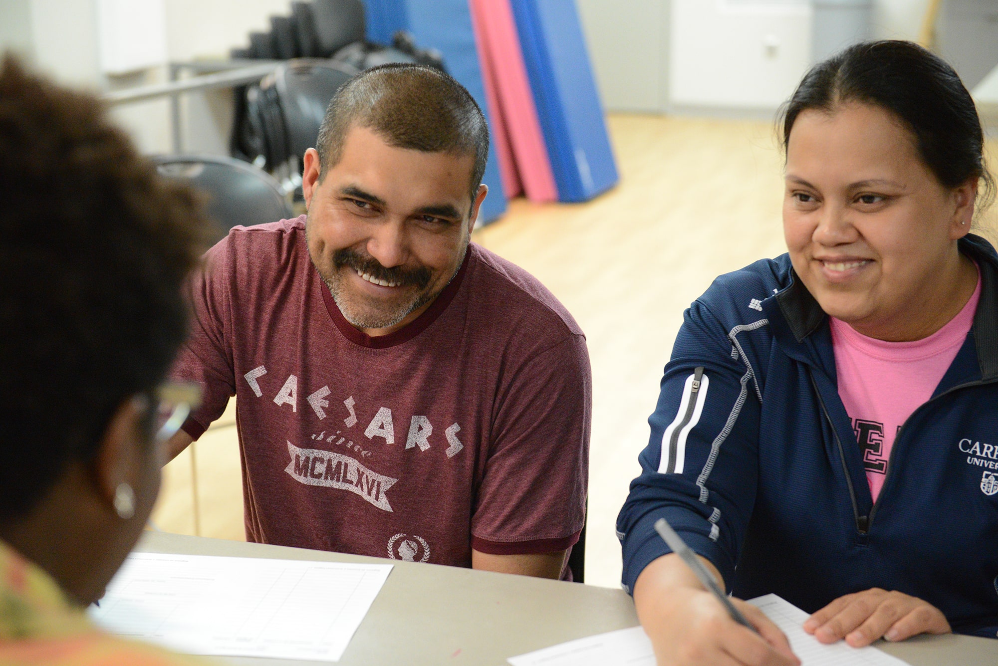 Greater Kansas City YMCA Team Member instructing YMCA members on disease prevention and YMCA members taking notes.